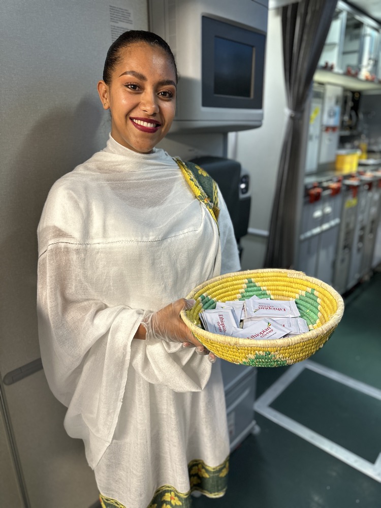 a woman holding a basket of tea packets