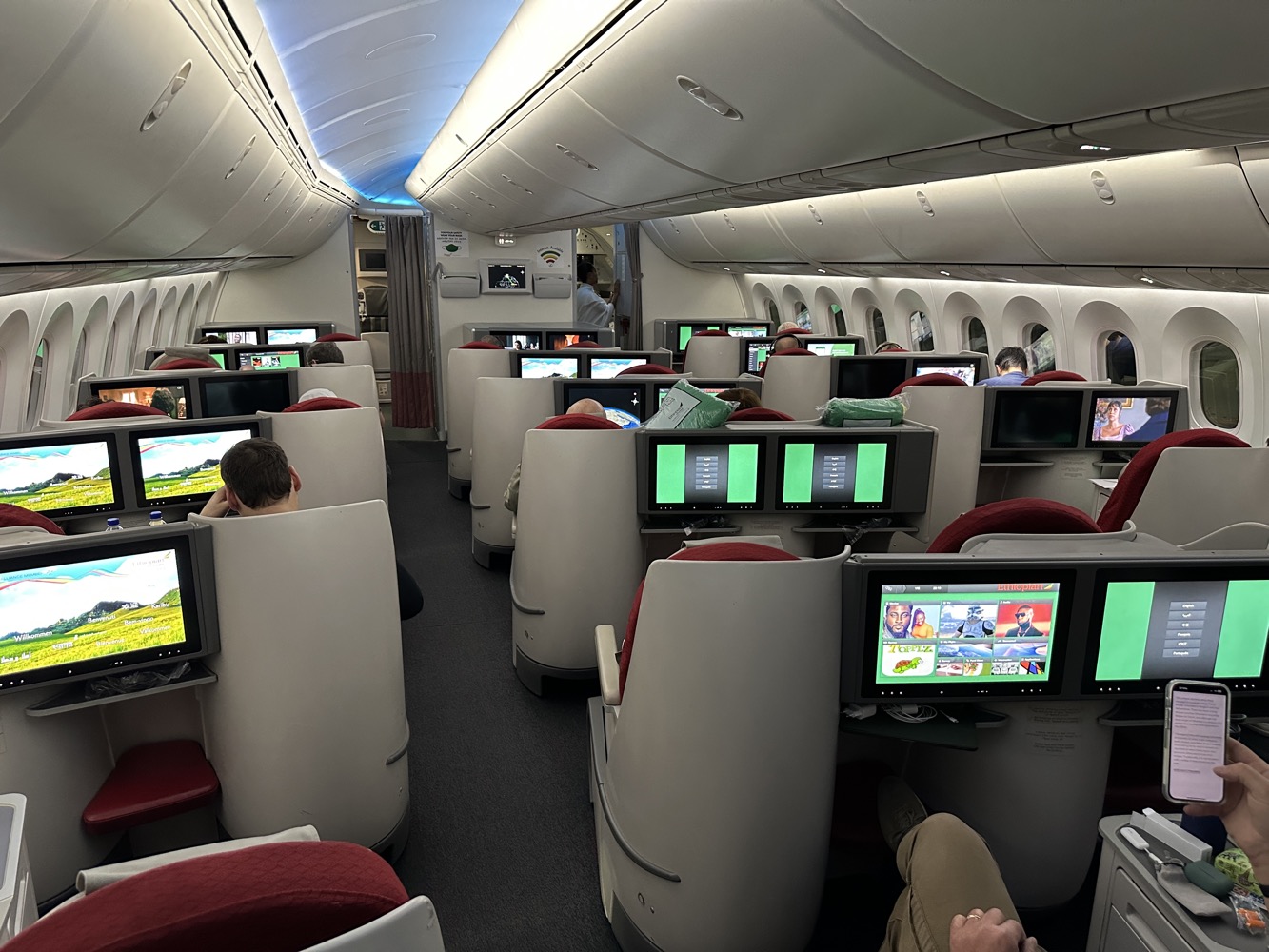 a group of people sitting in chairs in an airplane