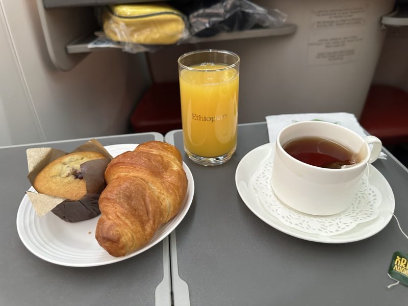 a plate of food and a cup of tea on a tray