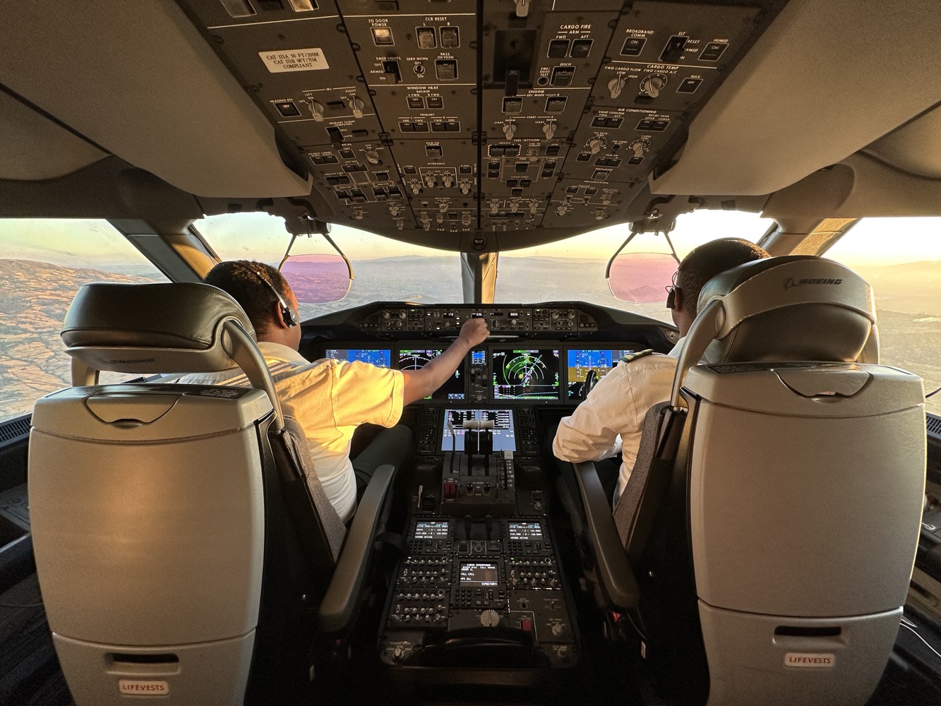 two men in the cockpit of an airplane