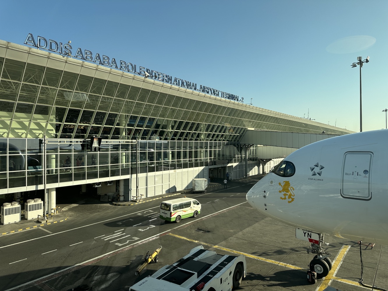 a white airplane parked in front of a building