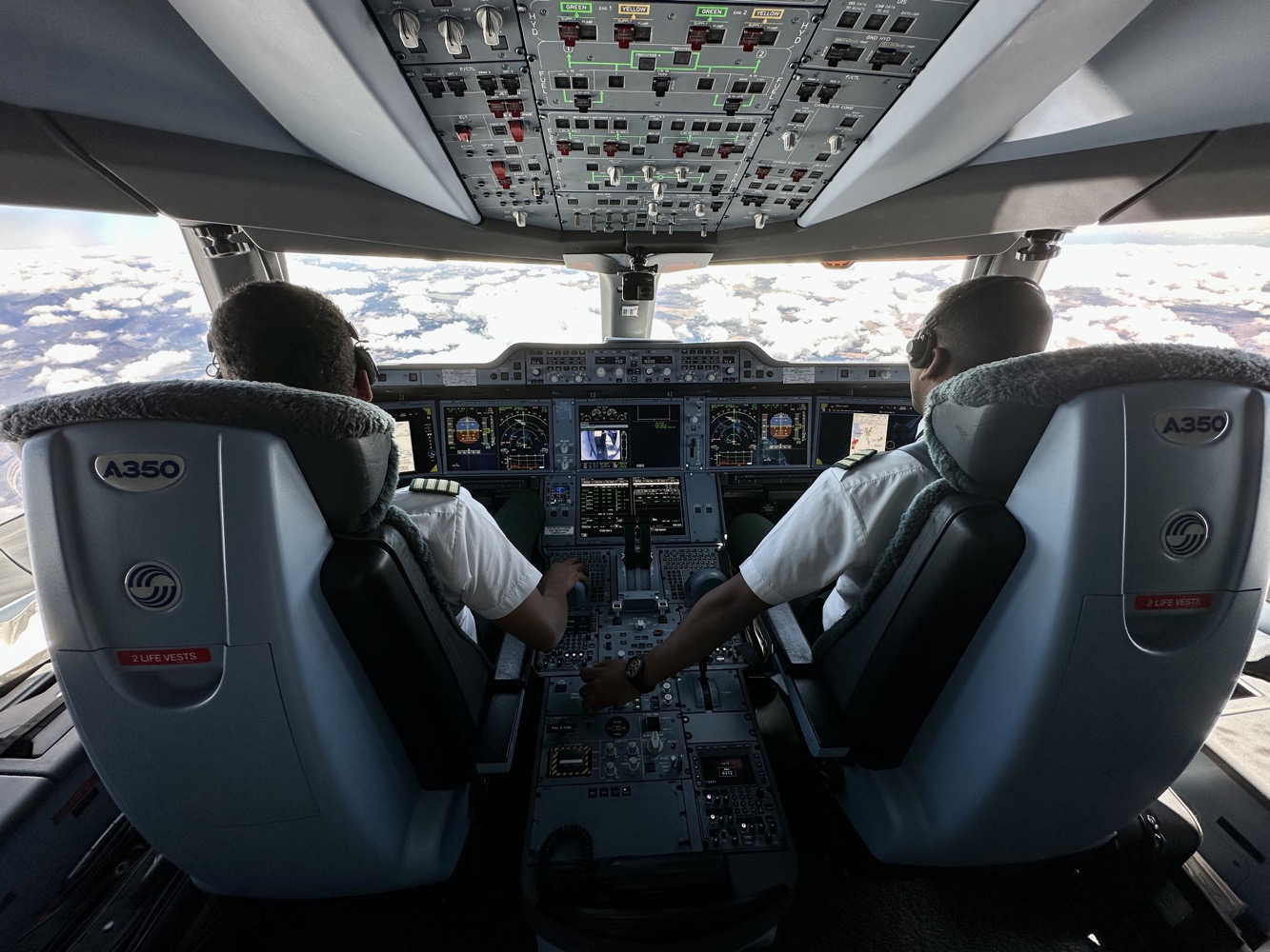 two men in the cockpit of an airplane