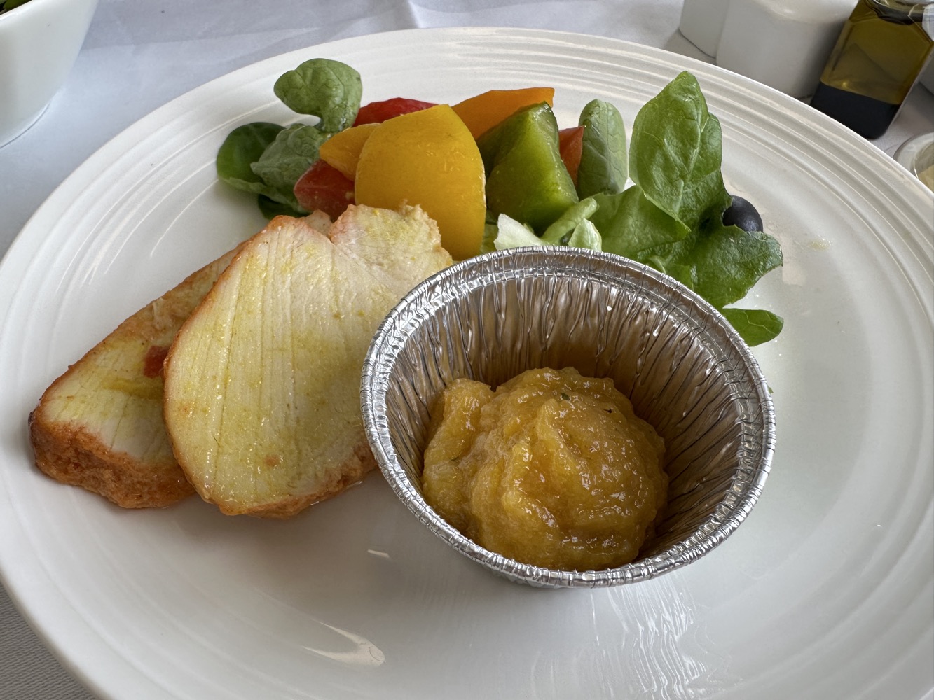 a plate of food with a small tin of food