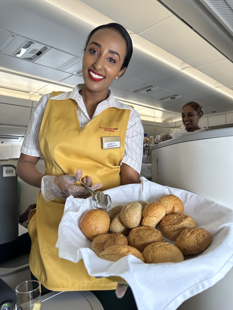 a woman holding a bowl of bread