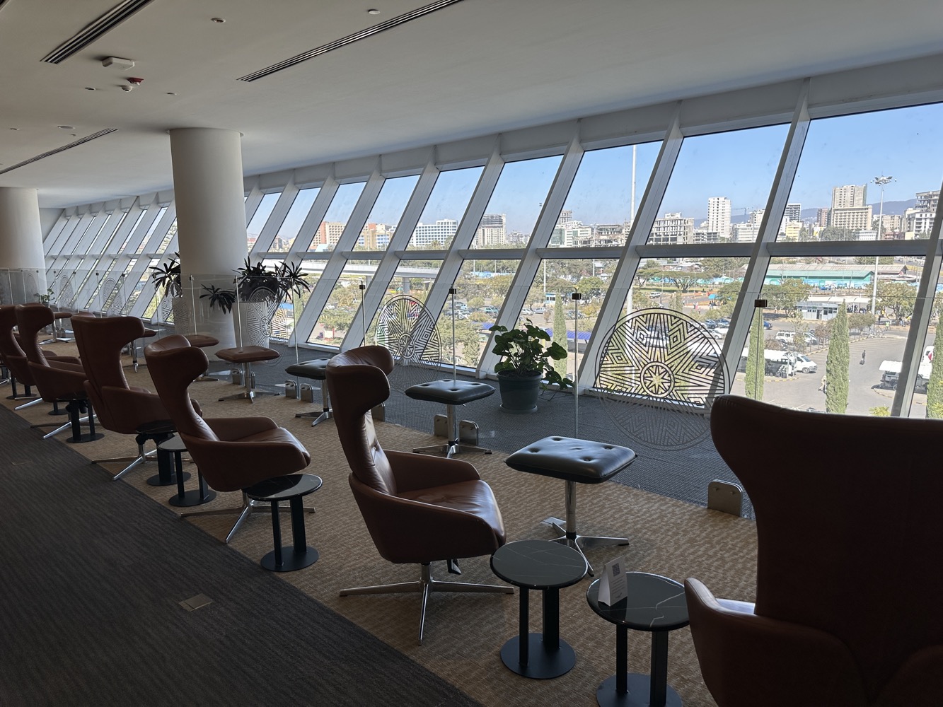 a room with chairs and tables and windows