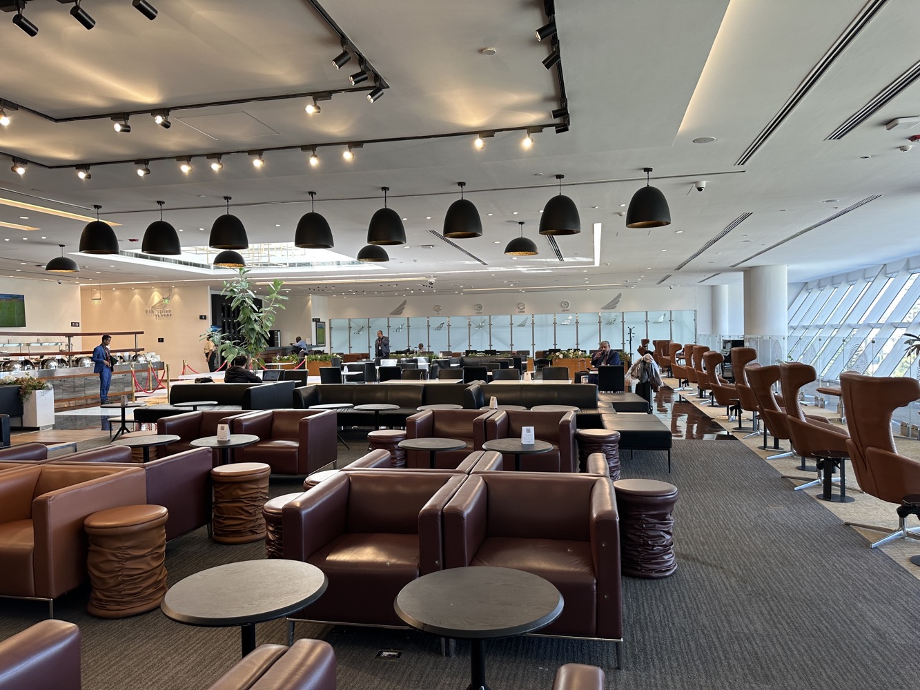 a lounge area with chairs and tables