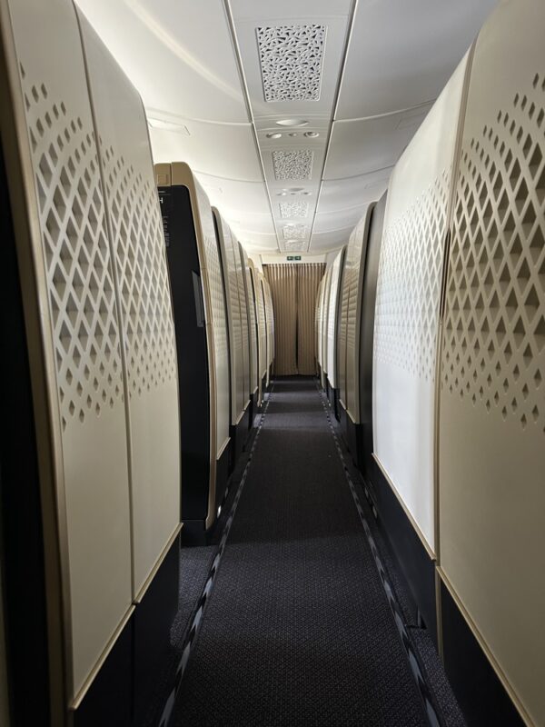 a long hallway with rows of white cabinets