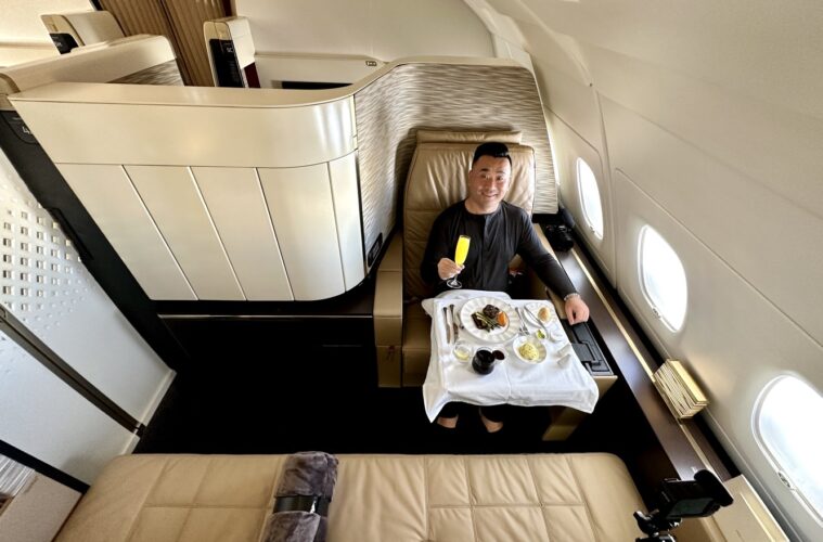 a man sitting in a chair with food on it