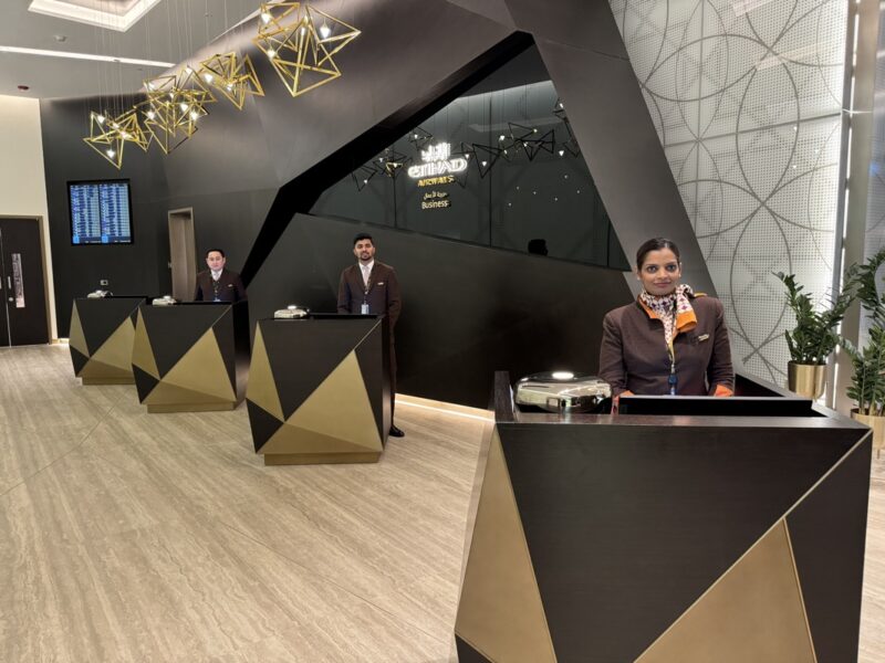 people standing at desks in front of a building