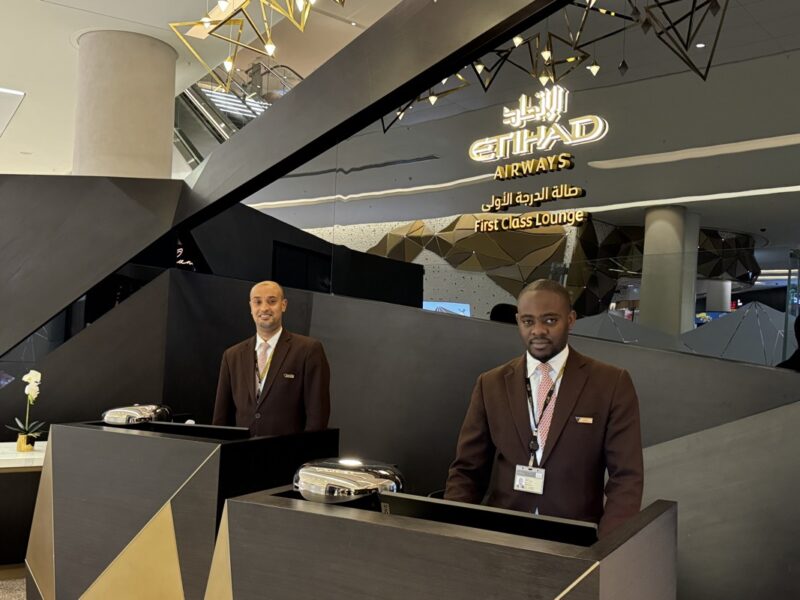 two men standing at a desk