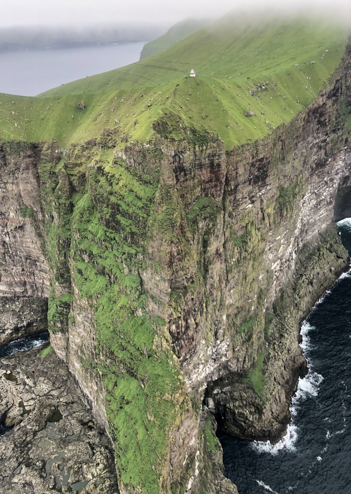 a cliff with a lighthouse on it