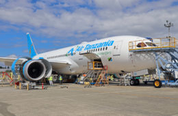 a large white airplane with blue letters on it