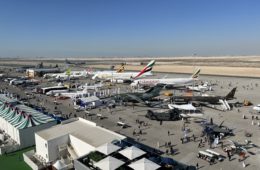 an airport with airplanes and people