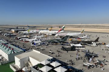 an airport with airplanes and people