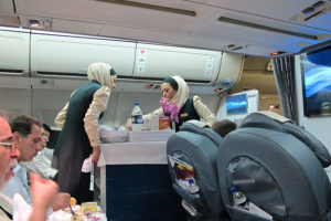 a group of women in uniform standing in an airplane