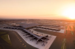 an airport with a large building and runway