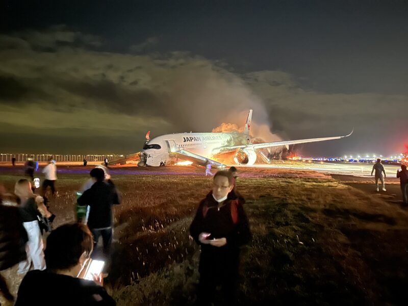 a group of people standing around an airplane