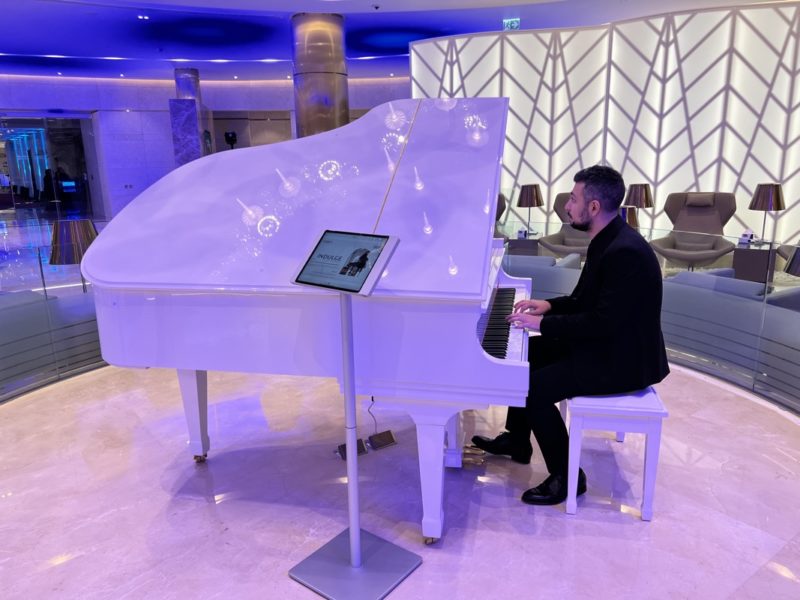 a man playing a white piano