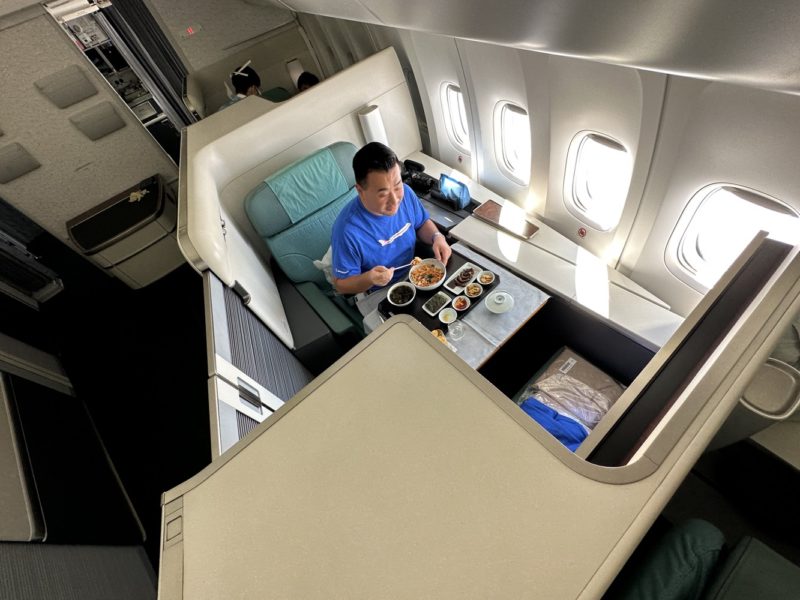 a man eating food on an airplane