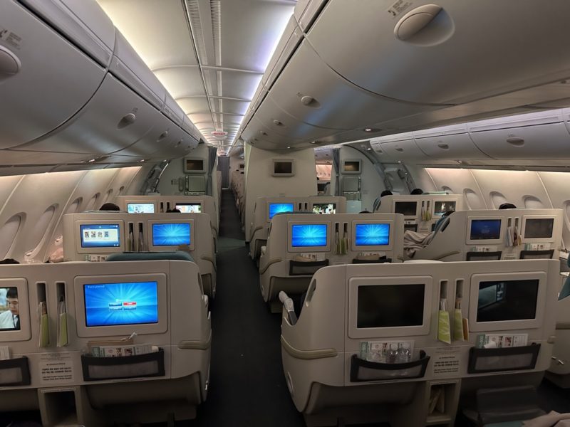 a row of seats with monitors on the side