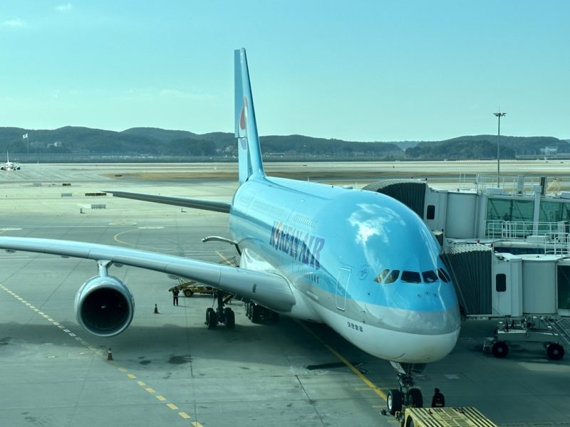 a blue airplane at an airport