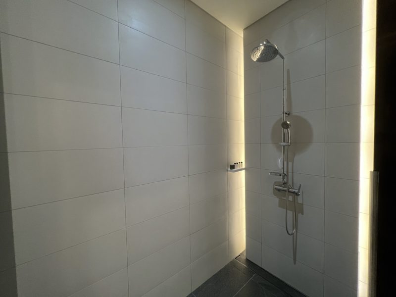 a shower with a light shining on the wall