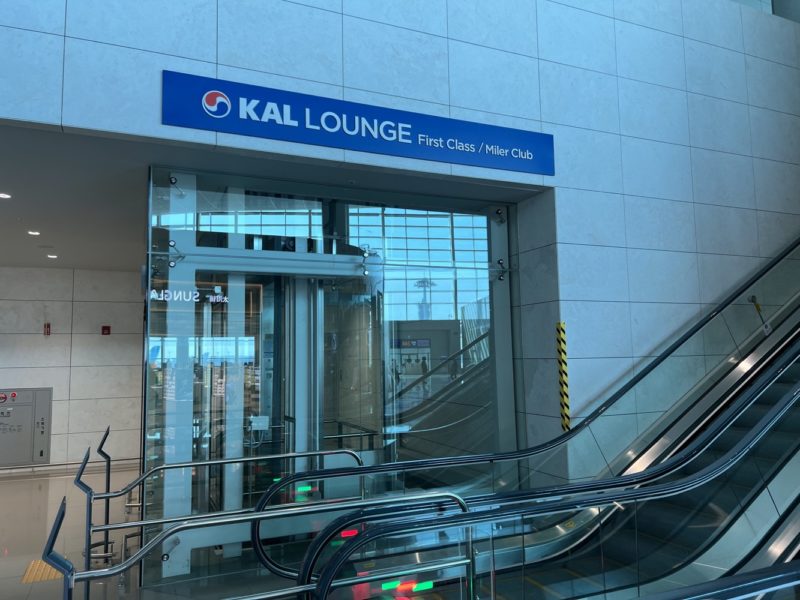 a escalator and a sign in front of a building