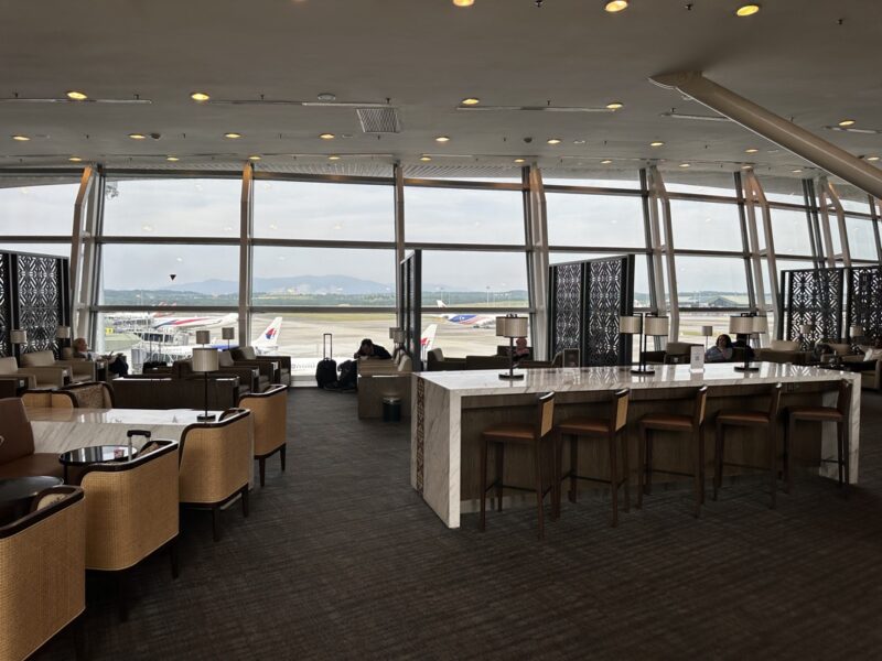 a room with tables and chairs and a large window