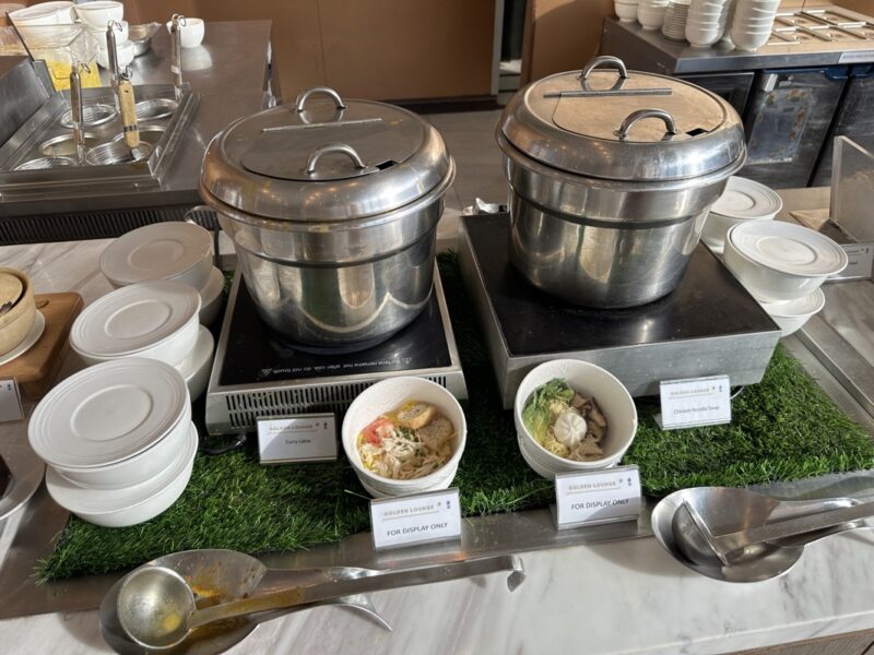 a group of pots on a table with bowls and plates