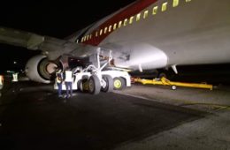 a man standing next to a plane