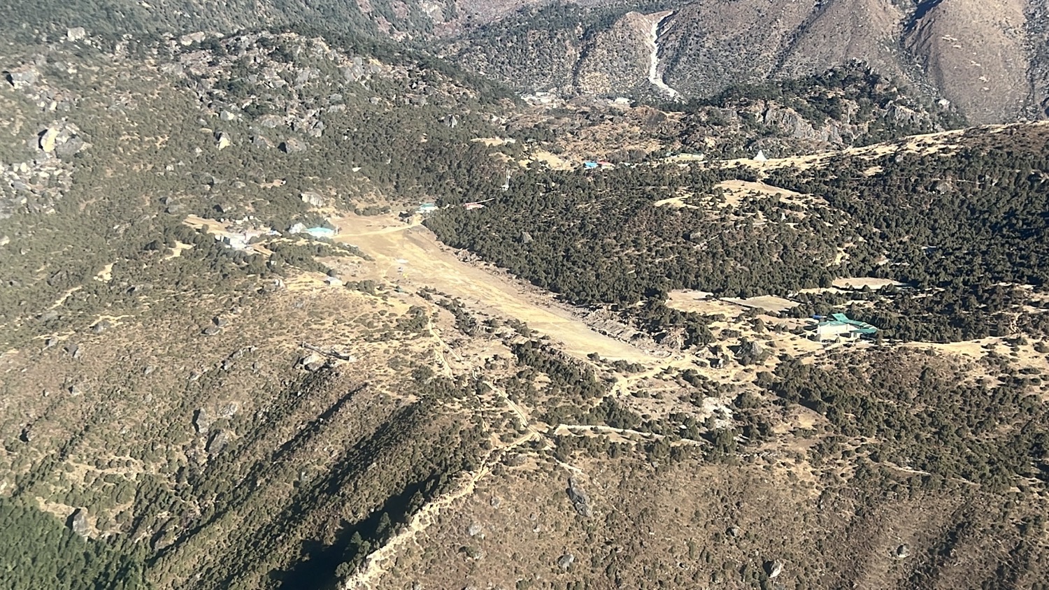 a landscape of a valley with trees and mountains