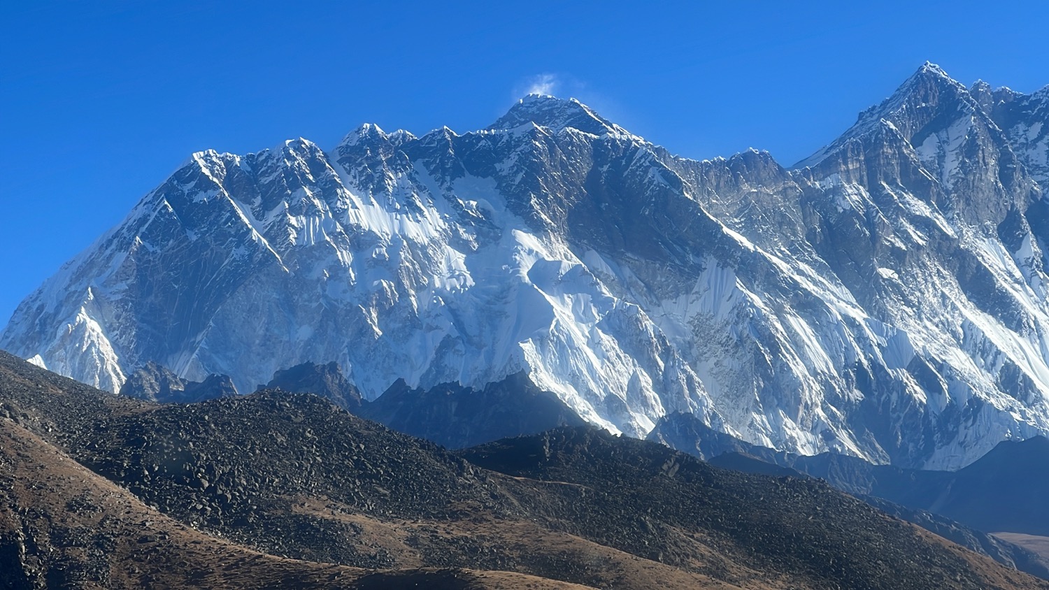 a snowy mountain with blue sky