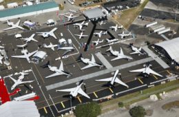 an aerial view of airplanes on a runway