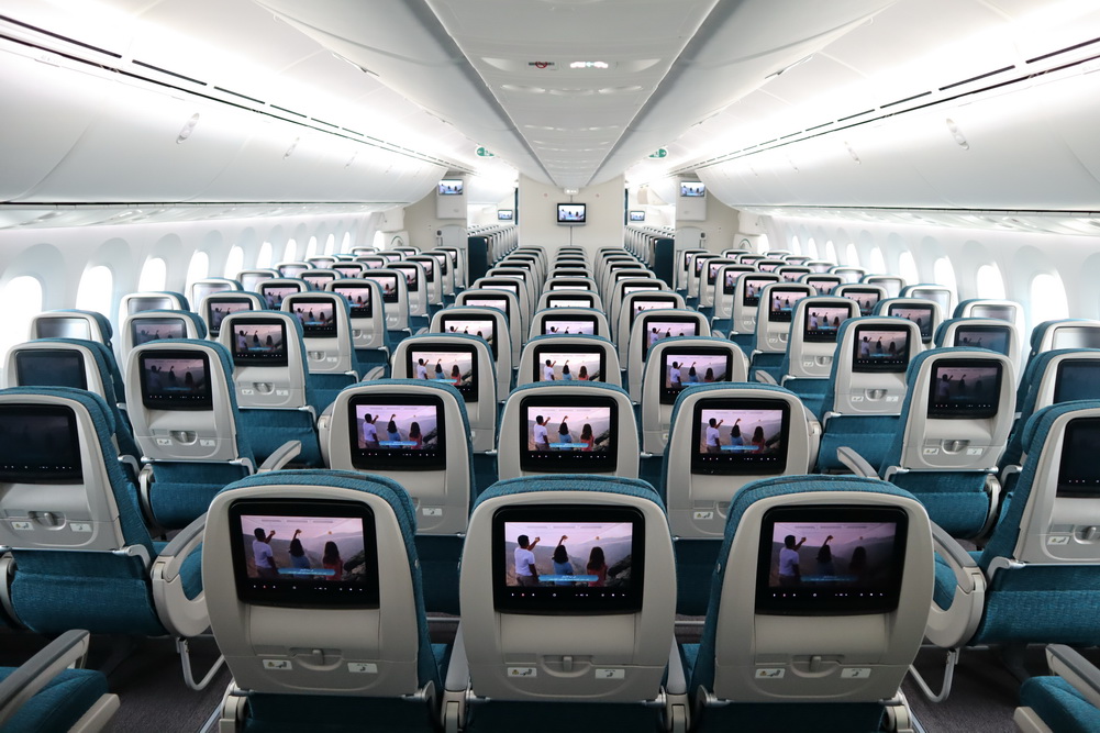 an airplane with rows of seats and monitors