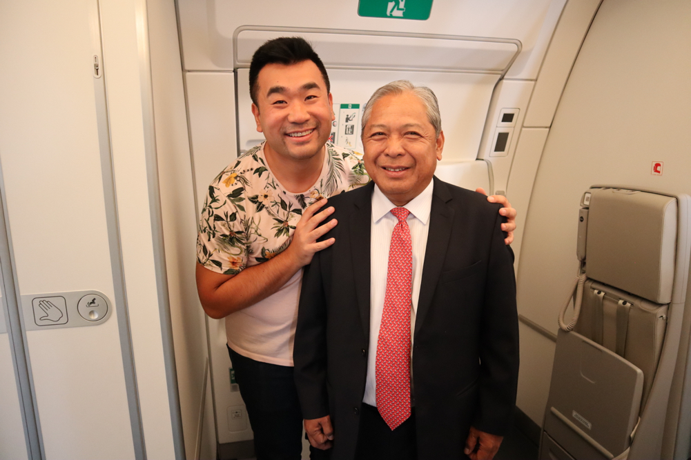 two men standing in a plane