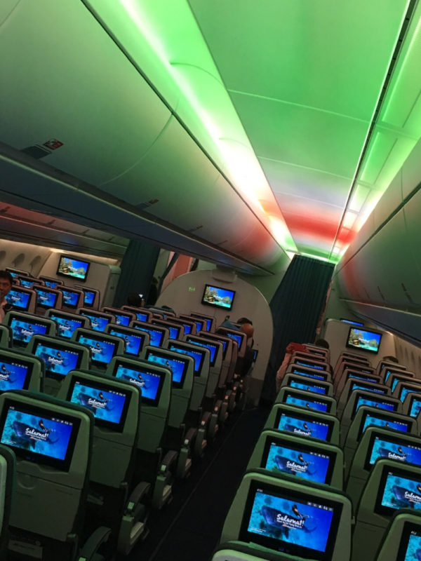 a row of seats with monitors on the side