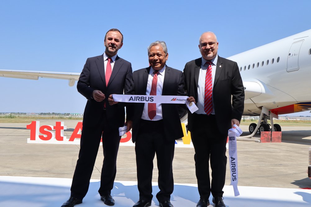 a group of men in suits holding a ribbon