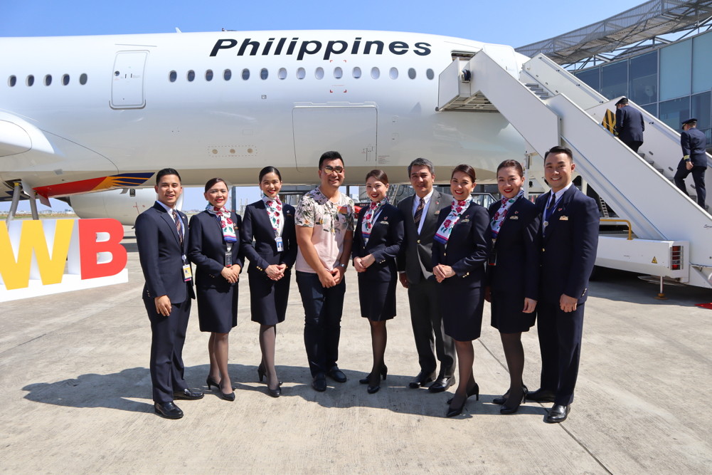 a group of people in uniform standing in front of an airplane