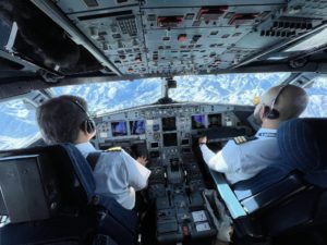 two men in the cockpit of an airplane