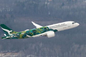 a white and green airplane flying in the sky