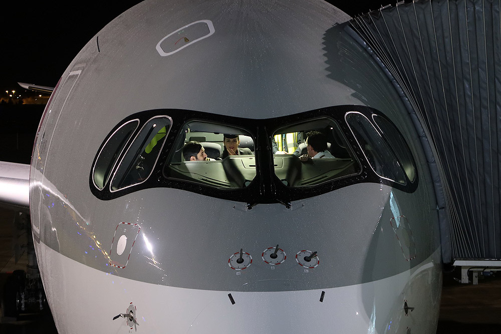 a group of people in the cockpit of an airplane