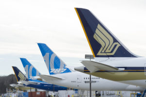 a group of airplanes parked in a row