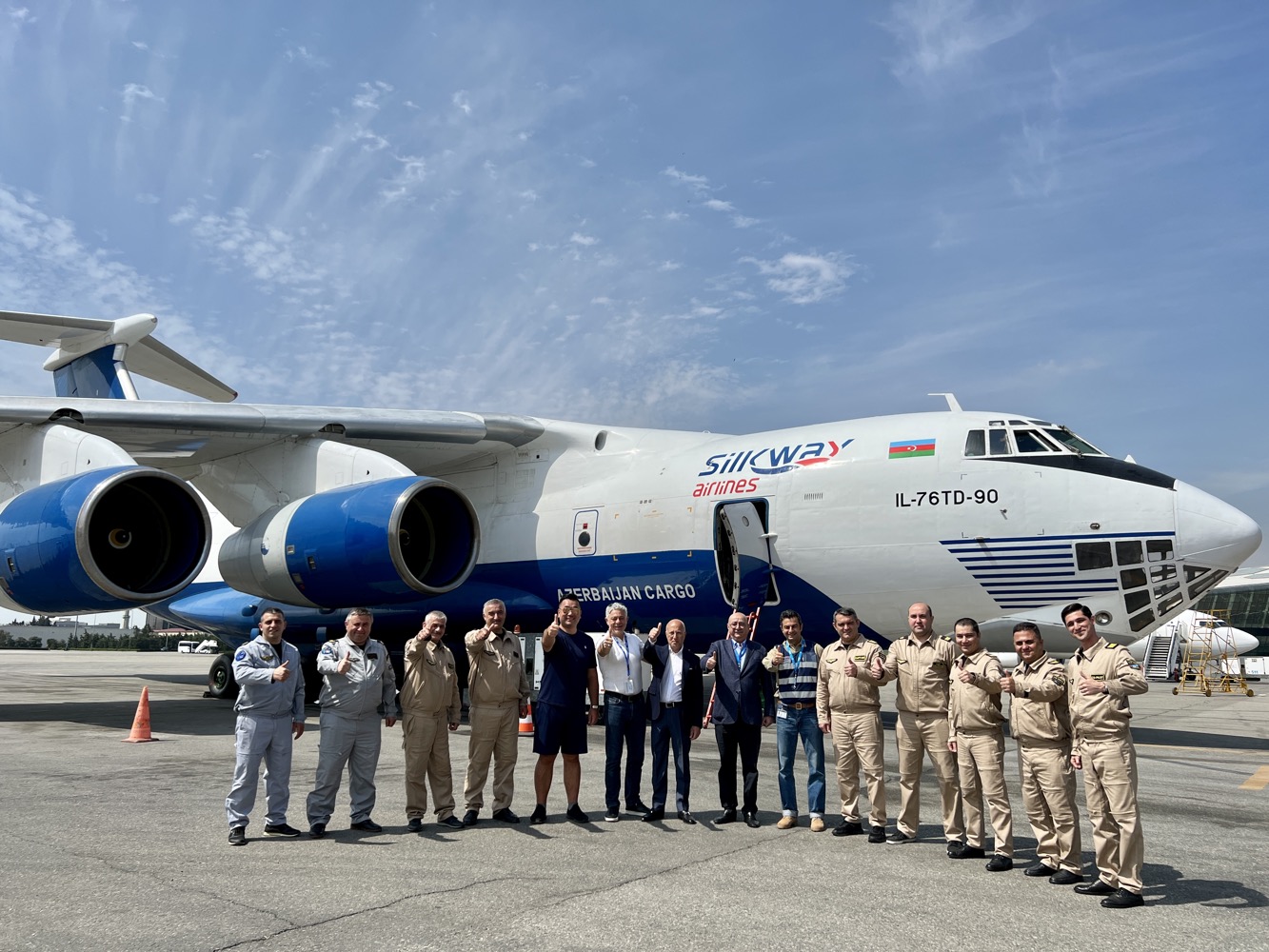 a group of people standing in front of an airplane