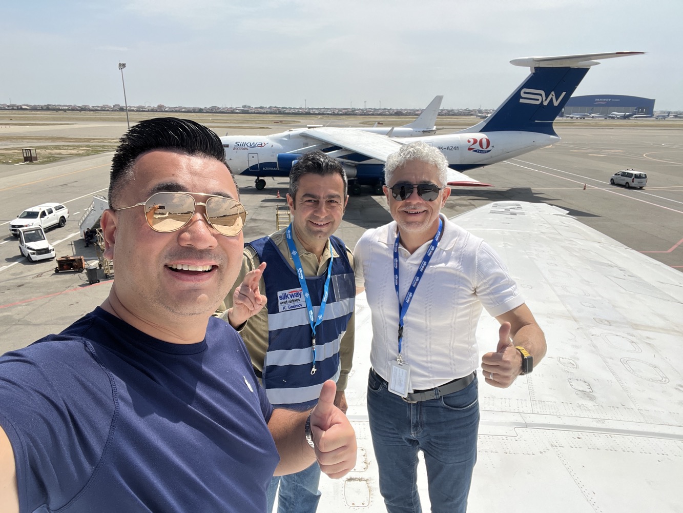 a group of men standing in front of an airplane