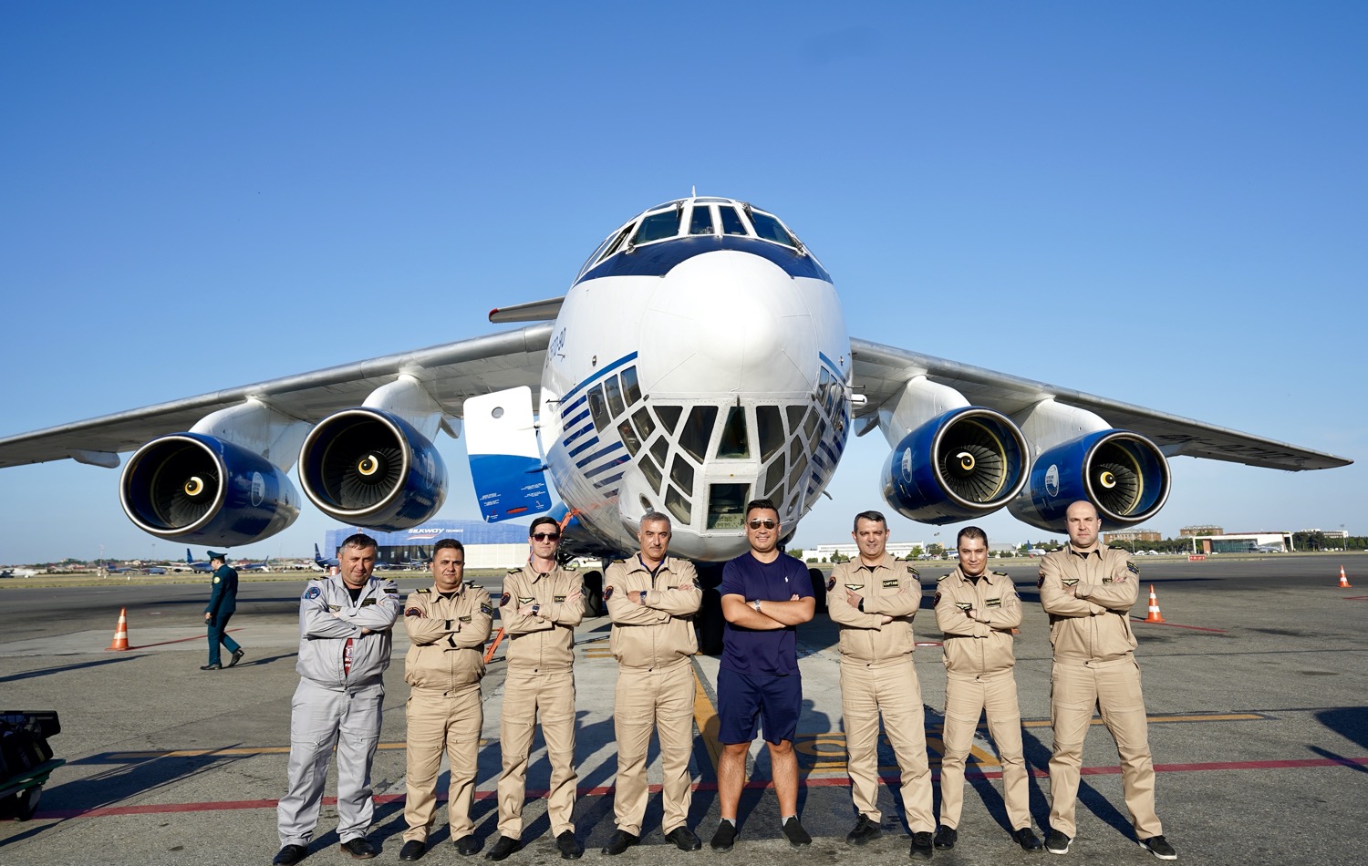 a group of men in uniform standing in front of a plane