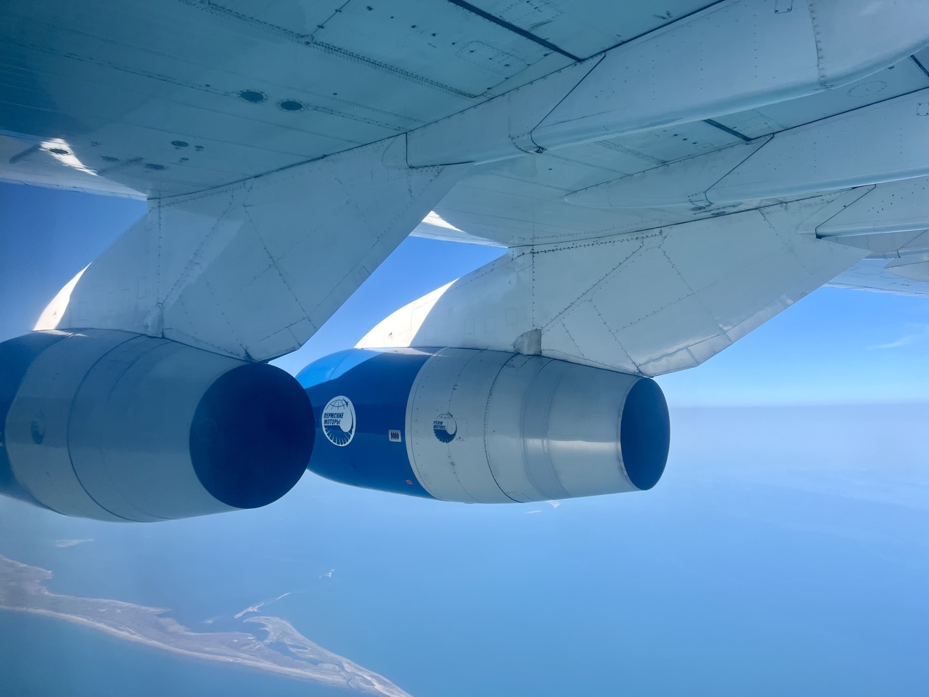 an airplane wing with a blue and white engine