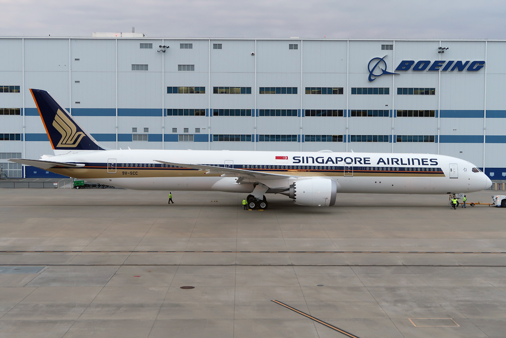 a large airplane parked in front of a building