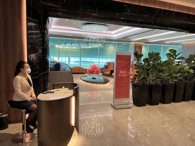 a woman sitting at a desk in a lobby