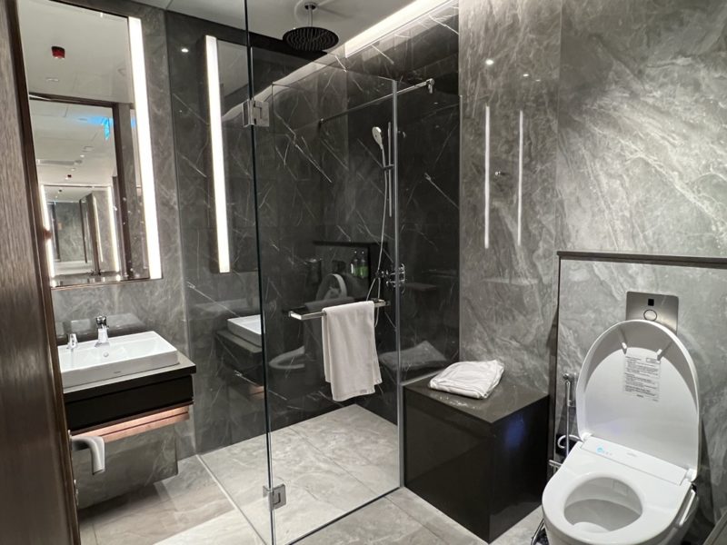 a bathroom with a glass shower and sink