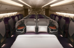 a bed and chairs in a plane